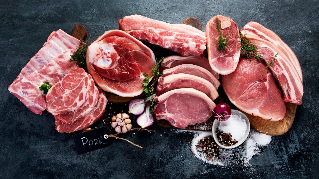 Different types of raw meat on black background